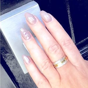 Sterling silver ring flanked by a gold spinner band.